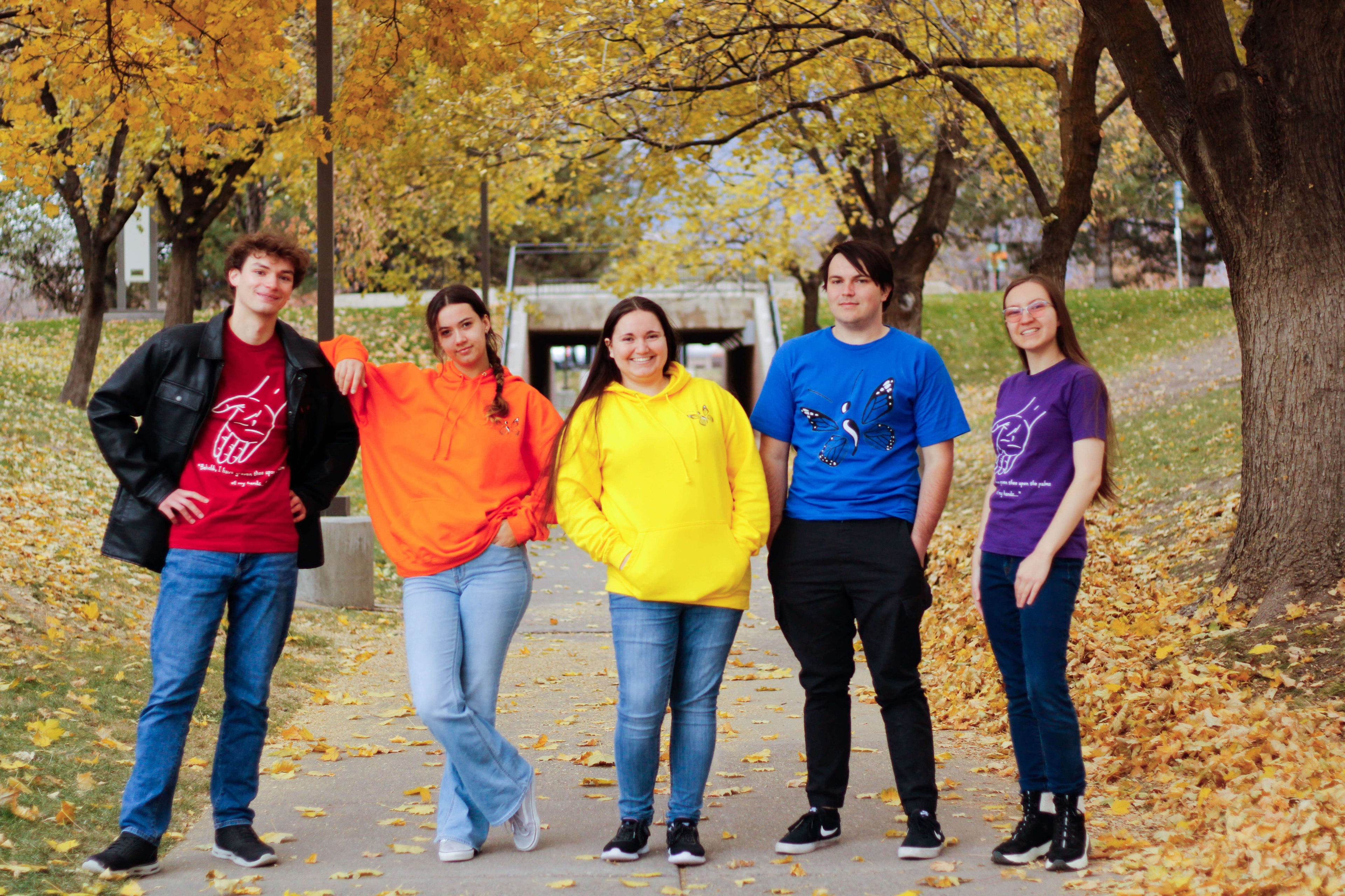 Five young adults wearing products from The Unqualified Artist.